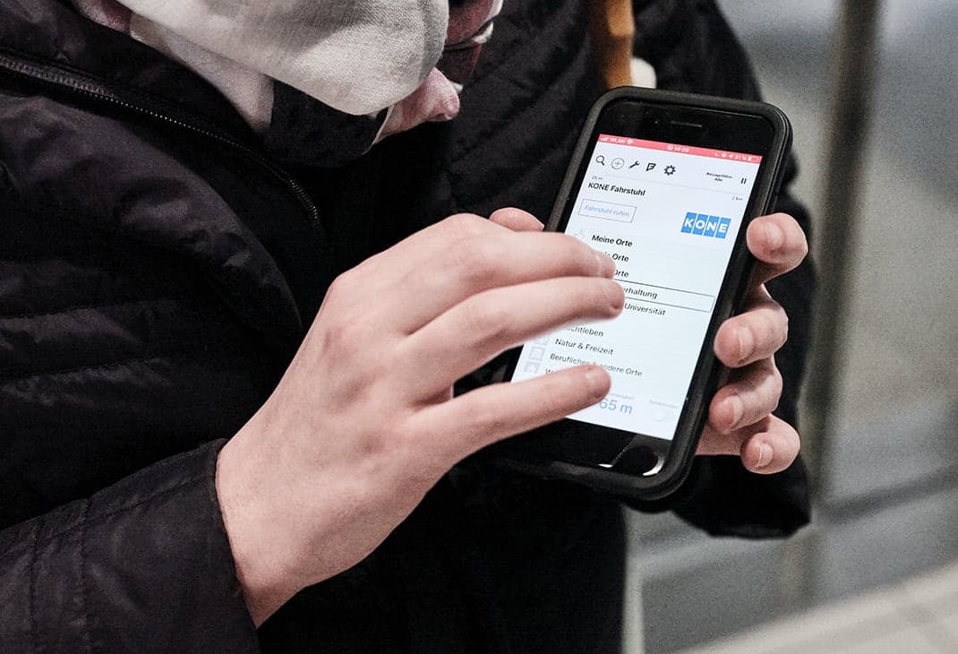 A woman who is blind using the BlindSquare application on her mobile phone.